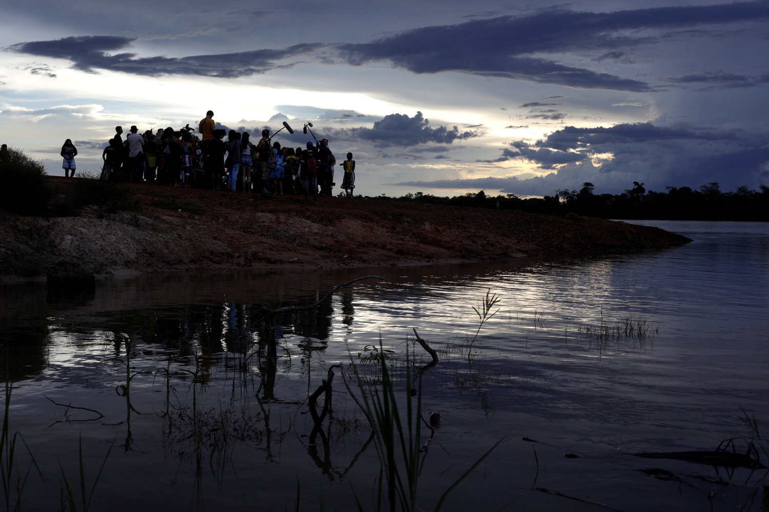 Indigenous people stand on the banks of the Xingu River during a media event in Brazil’s Xingu Indigenous Park Jan. 15, 2020.